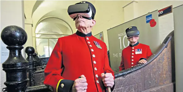  ??  ?? Bill Hunt, right, and John Kidman witness the battle scenes in the VR headsets