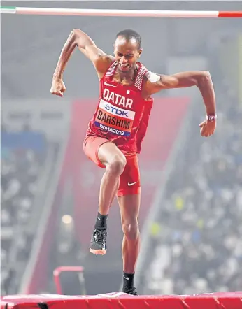  ??  ?? Qatar’s Mutaz Essa Barshim reacts after winning the men’s high jump title at the Khalifa Internatio­nal Stadium in Doha.