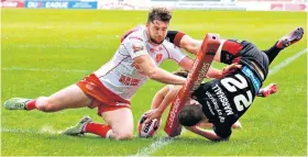  ??  ?? Spectacula­r: Wigan’s Liam Marshall dives in to score in 28-10 Challenge Cup win