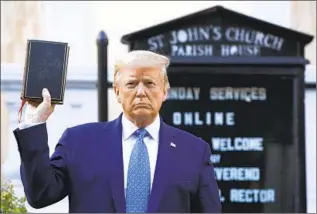 ?? Patrick Semansky Associated Press ?? DEMONSTRAT­ORS rallying for racial justice were forcefully cleared from an area near the White House before President Trump staged this photo-op in front of a church June 1.