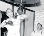  ??  ?? Below: Henry Cooper training in 1963 and West Ham stars using dumbells in a 1959 finess session at their traing ground