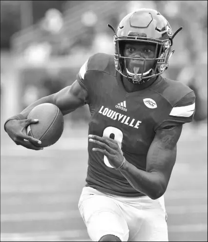  ?? TIMOTHY D. EASLEY/THE ASSOCIATED PRESS ?? Louisville quarterbac­k Lamar Jackson runs through an opening in the Florida State line during the 10thranked Cardinals’ 63-20 victory over No. 2 Florida State in Louisville, Ky., on Saturday. Jackson ran for four touchdowns and passed for a fifth in...