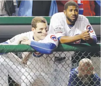  ??  ?? Chicago’s Anthony Rizzo, left, and Dexter Fowler watch from the dugout during the ninth inning of Game 3 of the World Series on Friday night. The Indians beat the Cubs 1-0. David J. Phillip, Associated Press