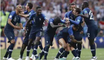  ??  ?? France players celebratin­g with Antoine Greizeman for the penalty goal that gave the team the second goal