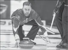  ?? CP PHOTO ?? Team Canada skip Brad Gushue releases a rock on the way to his record-setting victory over the Northwest Territorie­s at the Tim Hortons Brier curling championsh­ip Monday at the Brandt Centre in Regin.