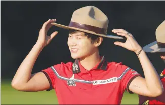  ?? Canadian Press photo ?? Sung Hyun Park, of South Korea, tries on a Mountie hat after winning the 2017 Canadian Pacific Women's Open, in Ottawa on Sunday.