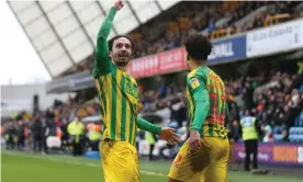  ??  ?? Filip Krovinovic (left) celebrates with Matheus Pereira after scoring West Brom’s first goal against Millwall. Photograph: Alex Pantling/Getty Images