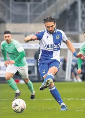  ??  ?? Bristol Rovers’ Luke Leahy scores his side’s fifth goal from the penalty spot