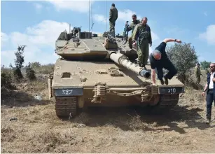  ?? ( Ariel Hermoni/ Defense Ministry) ?? DEFENSE MINISTER Avigdor Liberman jumps off a tank on a visit Tuesday with the armored corps in the Golan Heights.