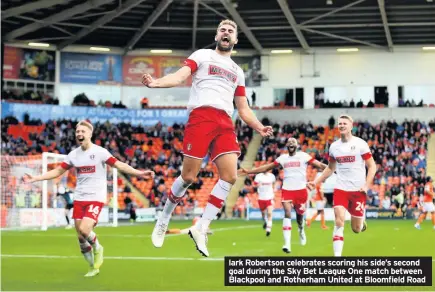  ??  ?? lark Robertson celebrates scoring his side’s second goal during the Sky Bet League One match between Blackpool and Rotherham United at Bloomfield Road