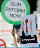  ??  ?? FLORIDA: Protesters hold signs at a rally for gun control at the Broward County Federal Courthouse in Fort Lauderdale, Florida. Seventeen perished and more than a dozen were wounded in the hail of bullets at Marjory Stoneman Douglas High School in...