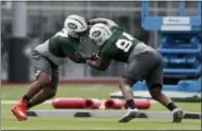  ?? THE ASSOCIATED PRESS ?? New York Jets’ Nathan Shepherd, left, who was drafted in the third round of the 2018draft, works out with Folorunso Fatukasi, who wad drafted in the sixth round, during NFL rookie camp, Saturday in Florham Park, N.J.