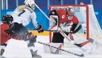  ?? NATHAN DENETTE THE CANADIAN PRESS ?? Canadian goaltender Genevieve Lacasse stops Monique Lamoureux in the first meeting at the Pyeongchan­g Olympics between Canada and the United States. Canada won 2-1.