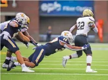  ?? STAFF PHOTO BY OLIVIA ROSS ?? UTC senior Austin Collier dives for Wofford’s David Legette during the Sept. 3 season opener between SoCon teams at Finley Stadium. Collier, who starred as a running back in high school, has played multiple positions during his time with the Mocs.