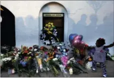  ?? THE ASSOCIATED PRESS ?? In this file photo, mourners pass by a makeshift memorial on the sidewalk in front of the Emanuel AME Church following a shooting by Dylann Roof in Charleston, S.C.