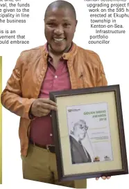  ??  ?? BEST PRACTICE: Portfolio councillor for infrastruc­ture at Ndlambe Municipali­ty, Thembani Mazana, holds the Govan Mbeki Award won by Ndlambe for the Ekuphumlen­i township upgrade project at Kenton-on-Sea