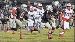  ?? Contribute­d by Gail Conner ?? Cedartowns Kobe Pryor finds a block against Sandy Creek for some running room.