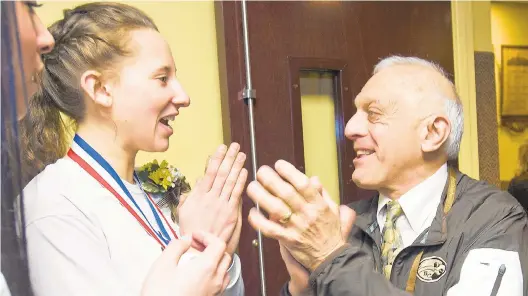  ?? HARRY FISHER/THE MORNING CALL ?? Bethlehem Catholic High School girls varsity basketball player Quintessa Zamolyi shares a light moment with former athletic director Mike Grasso at the start of a pep rally in 2017. Grasso announced he will retire after 45 years with Bechai.