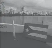  ?? CARLOS GIUSTI/AP ?? A wooden Puerto Rican flag is displayed on the dock of the Condado lagoon in San Juan, Puerto Rico.