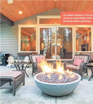  ??  ?? An outdoor fireplace or fire pit can be an easy addition when throwing outdoor gatherings.