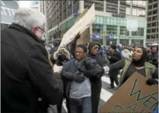  ?? RICK KAUFFMAN — DAILY TIMES ?? A plain-clothes Philadelph­ia police officer, left, clashes with Black Lives Matter protesters during the Mummers Parade.