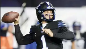  ?? GEORGE FREY, POOL — THE ASSOCIATED PRESS ?? BYU quarterbac­k Zach Wilson looks for a receiver during the first half of the team’s game against San Diego State last year in Provo, Utah.