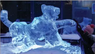  ?? MATTI MATIKAINEN / XINHUA ?? A child touches an ice sculpture exhibited during a Lunar New Year celebratio­n in Helsinki, Finland, on Jan 31.