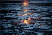  ?? ASSOCIATED PRESS FILE PHOTO ?? The midnight sun shines across sea ice along the Northwest Passage in the Canadian Arctic Archipelag­o in 2017.