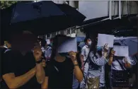  ?? LAMYIKFEI—THENEWYORK­TIMES ?? Protesters at a demonstrat­ion in Hong Kong use blank sheets of paper to convey that some slogans are now potentiall­y illegal under a new law that limits online speech.