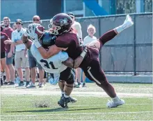  ?? GARY YOKOYAMA THE HAMILTON SPECTATOR ?? Deep in U of T territory McMaster’s Tommy Nield manages to wrestle his ball from Toronto’s Jordan Gillespie, during Saturday’s Homecoming Game.