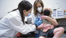  ?? SEAN RAYFORD / AP ?? Kaitlin Harring administer­s a Moderna COVID-19 vaccinatio­n to Fletcher Pack, 3, while he sits on his mother’s lap, at a Walgreens on Monday in Lexington, S.C.