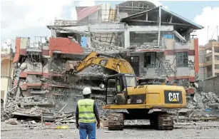  ?? Picture: REUTERS/ MONICAH MWANGI ?? TOTAL DESTRUCTIO­N: An engineer supervises the clearing of the ruins of an apartment block that collapsed after 200 tenants were evacuated in Ruiru, on the outskirts of Nairobi, Kenya this week.