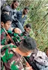  ?? AFP ?? A rescue team evacuates the boy from the crash site at menuk in Oksibil. —