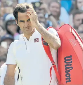  ?? BEN CURTIS — THE ASSOCIATED PRESS ?? Roger Federer prepares to leave the court after losing Wednesday’s quarterfin­al against Kevin Anderson 2-6, 6-7 (5), 7-5, 6-4, 13-11 in a match that lasted 4 hours, 14 minutes.