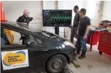  ?? ?? Automotive Professor Bob Brown, and students Paul Vanderveld­e and Patrick Bareuther analyze live data from a vehicle on the lab’s dynamomete­r.