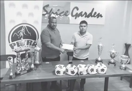  ?? ?? Petra Organizati­on Co-Director Troy Mendonca (left) presenting the cheque on behalf of the trio of sponsors to Neil Henrito, lead coordinato­r of the Upper Mazaruni Inter-Village u18 Football Championsh­ip