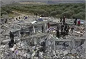  ?? GHAITH ALSAYED — THE ASSOCIATED PRESS ?? Civil defense workers and residents search through the rubble of collapsed buildings in the town of Harem near the Turkish border, Idlib province, Syria, Feb. 6, 2023.