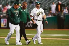  ?? Jeff Chiu / Associated Press ?? Stephen Vogt (right) of the A’s hasn’t played since leaving an April 20 game against the Orioles because of an injury.