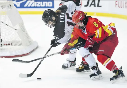  ?? ATSUSHI TOMURA/GETTY IMAGES FILES ?? Di Deng, right, and China’s national women’s hockey team are hoping to give the country something to cheer for at the 2022 Winter Games in Beijing.