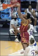  ?? AP photo ?? Evan Mobley of Southern Cal dunks as Kansas’ Ochai Agbaji defends during the Trojans’ 8551 win over the Jayhawks in the second round of the NCAA Tournament on Monday.