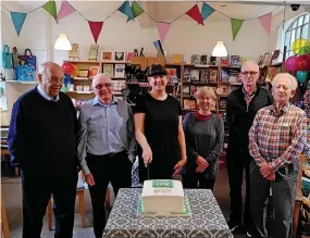  ?? ?? 20th anniversar­y celebratio­ns of The Vine, in Hinckley, with manager Jessica Harrison and trustees, with a celebratio­n cake