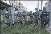  ?? ALEX BRANDON — THE ASSOCIATED PRESS FILE ?? The District of Columbia National Guard and U.S. Park Police advance in front of the AFL-CIO headquarte­rs in Washington as they move back demonstrat­ors protesting the death of George Floyd.