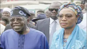  ?? James Oatway) (Pic: Reuters/ ?? Presidenti­al candidate Bola Ahmed Tinubu with his wife Oluremi Tinubu at a polling station before casting his ballot in Ikeja, Lagos.