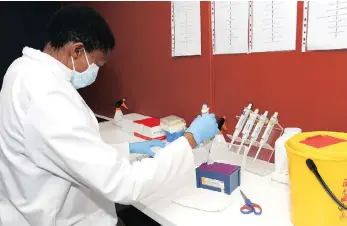  ?? PICTURE: LEON LESTRADE ?? Laboratory technician Onkabetse Motaung completes a test at Genediagno­stics in Somerset West this week.