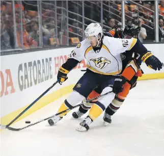  ?? SEAN M. HAFFEY/GETTY IMAGES ?? Nashville Predators centre Ryan Johansen, front, seen protecting the puck from Anaheim Ducks centre Ryan Kesler in Game 2 on Sunday in Anaheim, Calif., is “a skilled player and I play the game hard. Obviously he doesn't like that,” Kesler says.