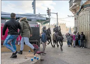  ?? The New York Times/URIEL SINAI ?? Israeli mounted police move against Palestinia­n demonstrat­ors Thursday during a clash at the Damascus Gate outside the Old City of Jerusalem. Israeli forces braced for more violence today.