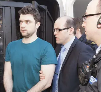  ??  ?? Pictured right is Richard McLoughlin with Garda Gearoid Conneely arriving at a sitting of Donegal District Court on Monday where he was remanded in custody charged with Mr Loughlin’s murder.