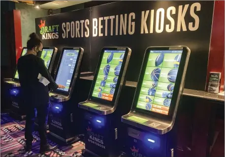  ?? SUSAN HAIGH, FILE — THE ASSOCIATED PRESS ?? In this Thursday Sept. 30, 2021, file photo, Zach Young of New Haven, Conn., places a bet at one of the sports wagering kiosks at Foxwoods Resort Casino in Mashantuck­et, Conn.