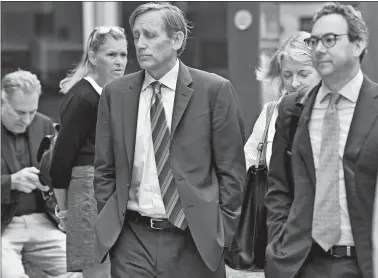  ?? JOSH REYNOLDS/AP PHOTO ?? Jeffrey Bizzack, center, arrives at federal court with members of his defense team Wednesday in Boston. He pleaded guilty for allegedly paying to get his son into the University of Southern California as a fake volleyball recruit.