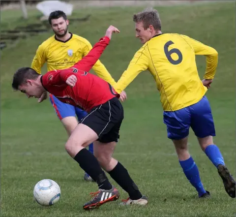  ??  ?? Donal Kiely of St. Leonards is tracked by Seán Keane of Curracloe United during their Division 1 match.